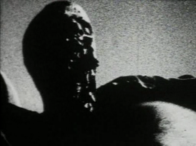 Close-up of the mud-covered 'Son of Earth' character from Begotten.